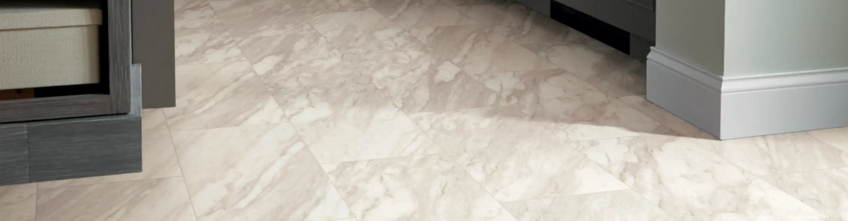neutral tile flooring in a kitchen with dark wood cabinetry